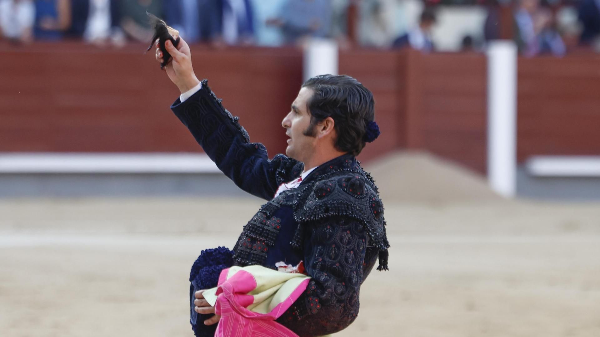 El diestro Morante de la Puebla muestra el trofeo conseguido en la faena a su segundo toro durante la Corrida de la Beneficencia