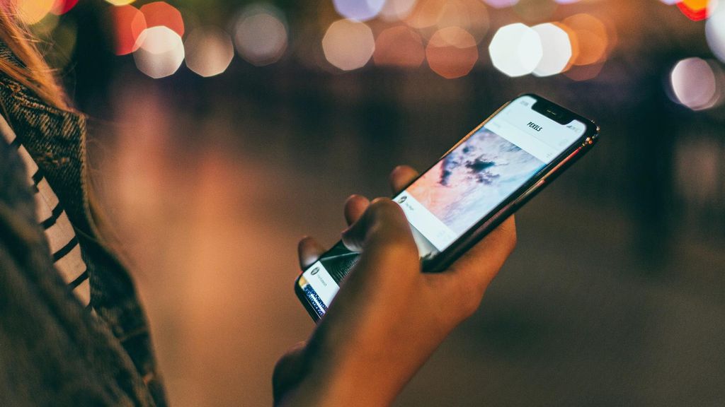 Una joven consulta los mensajes de sus redes sociales