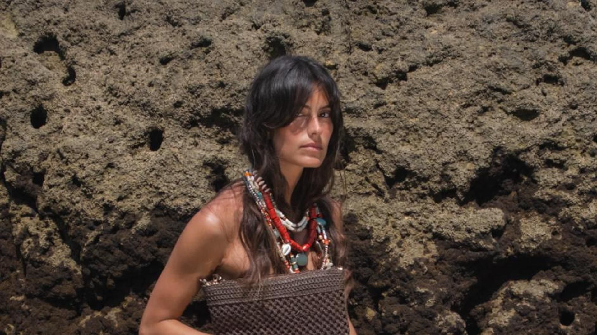Mujer en la playa con bolso de Parfois