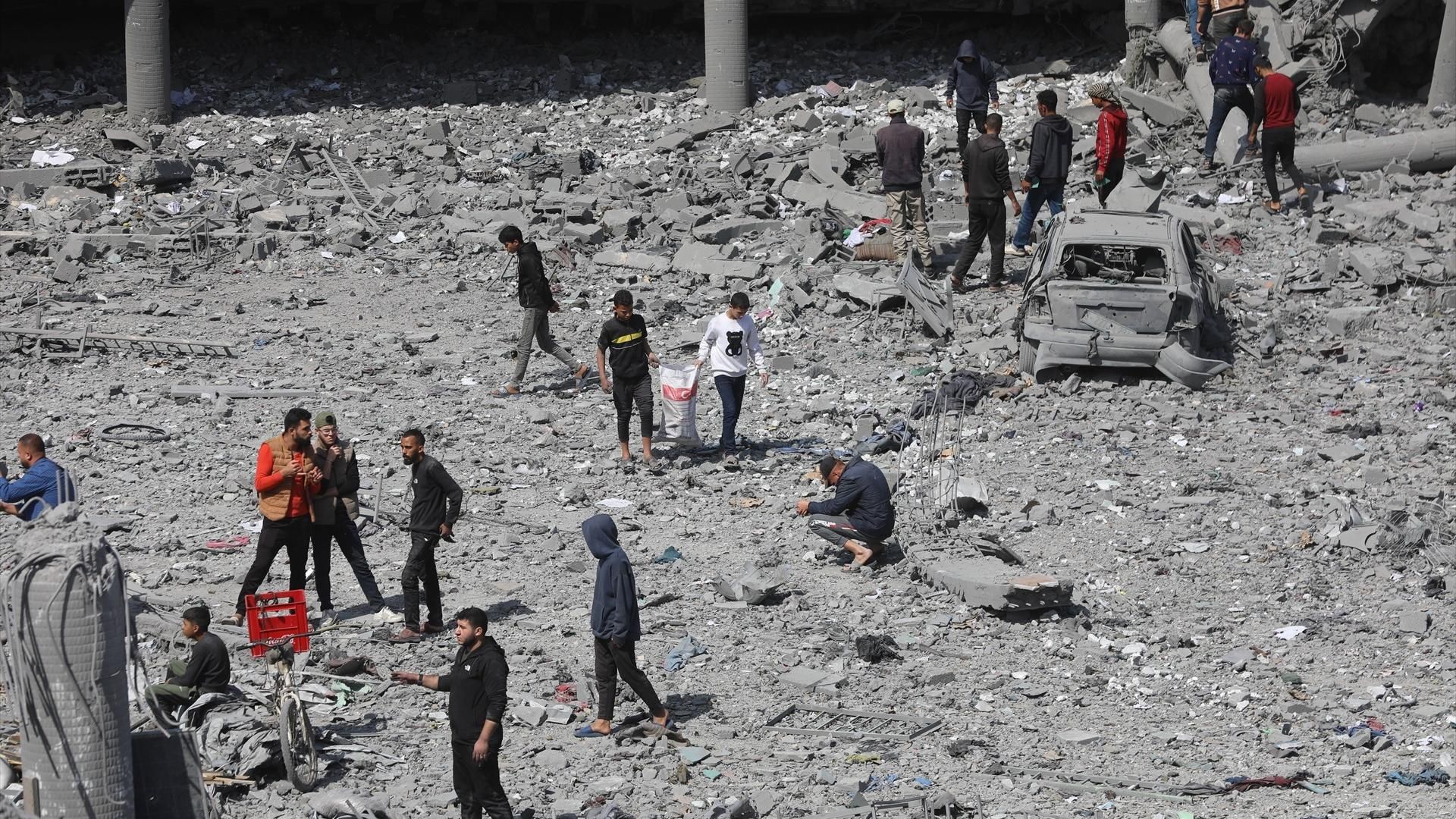 Palestinos intentan recuperar sus pertenencias tras un bombardeo de Israel contra una escuela que acogía a desplazados en el este de la ciudad de Gaza, en el norte de la Franja de Gaza