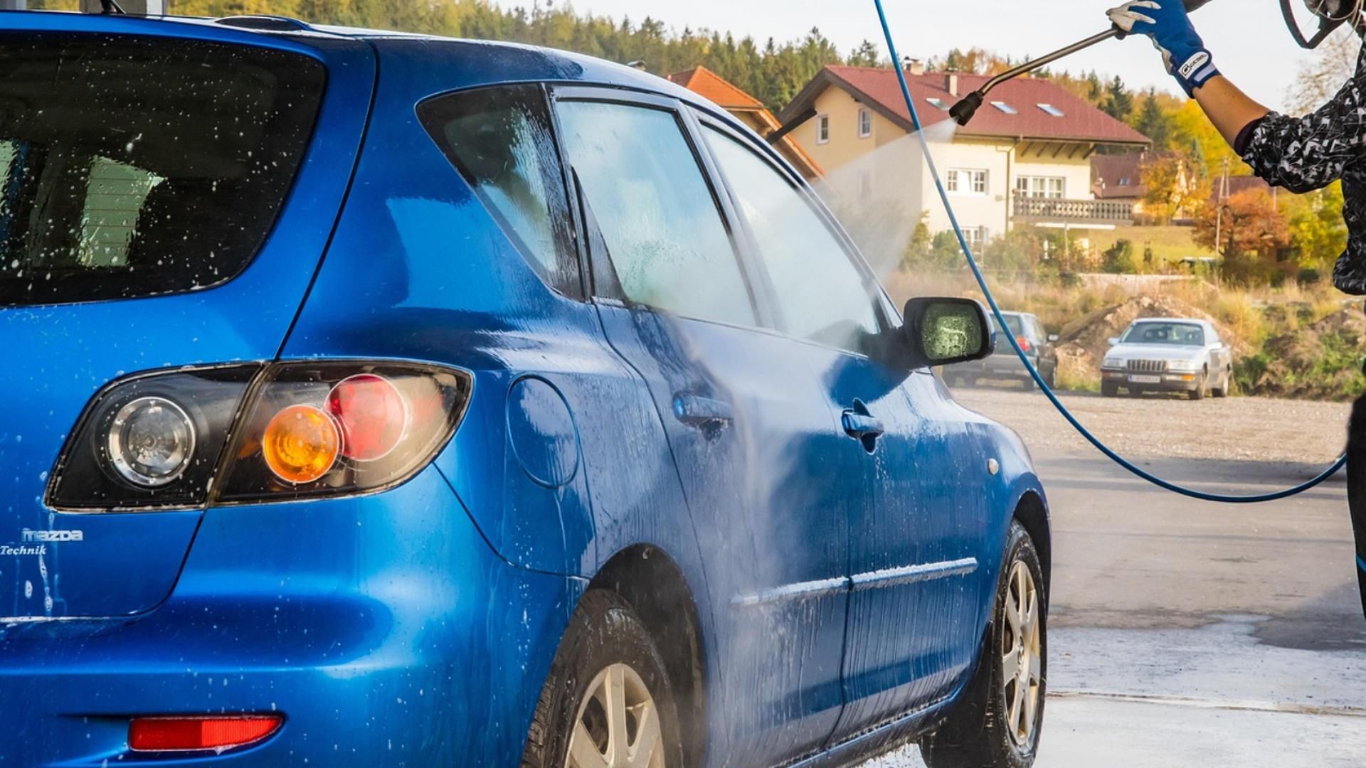 Un coche lavado con manguera a presión