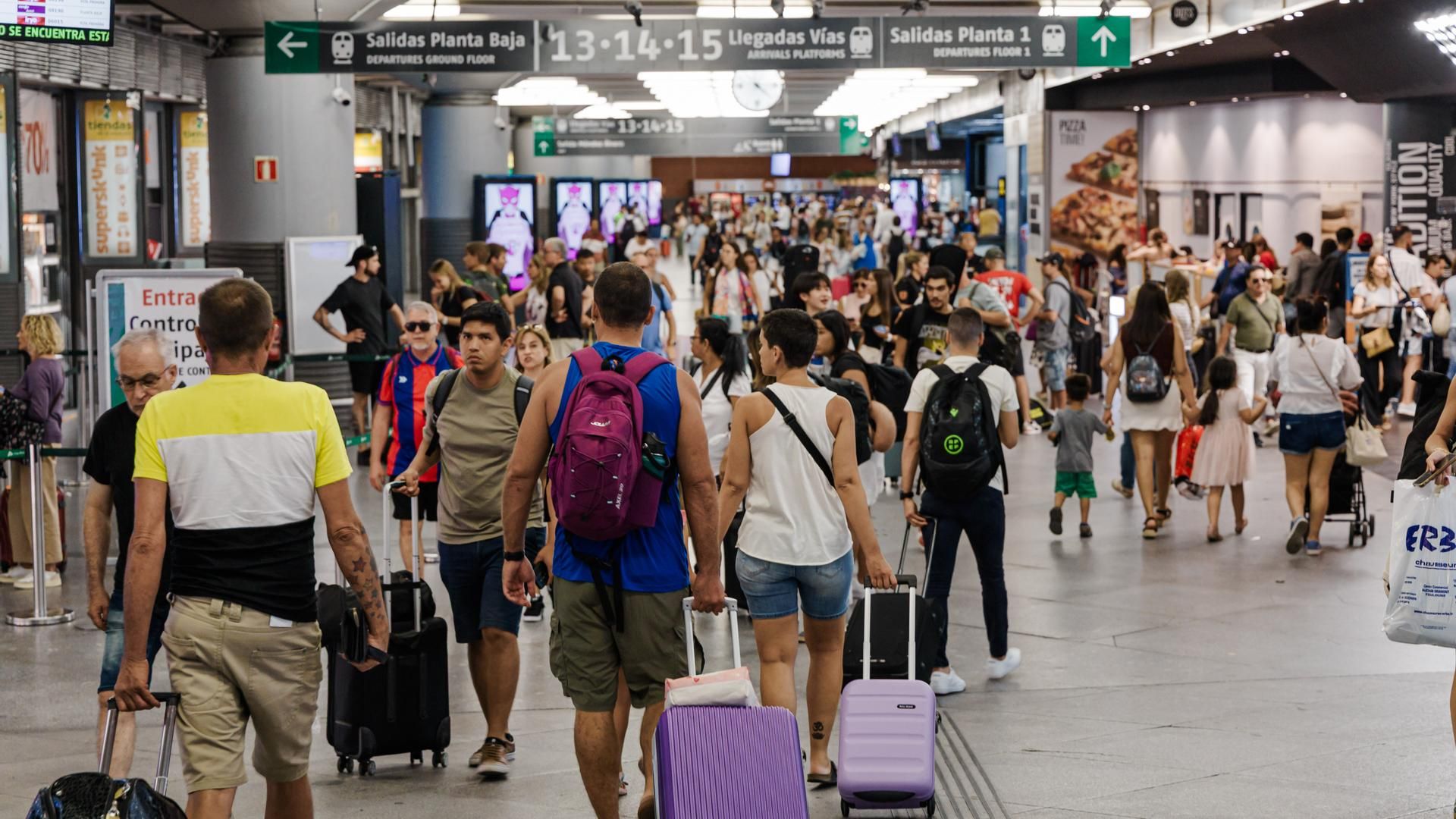 Decenas de personas caminan por la Estación de Madrid - Puerta de Atocha - Almudena Grandes