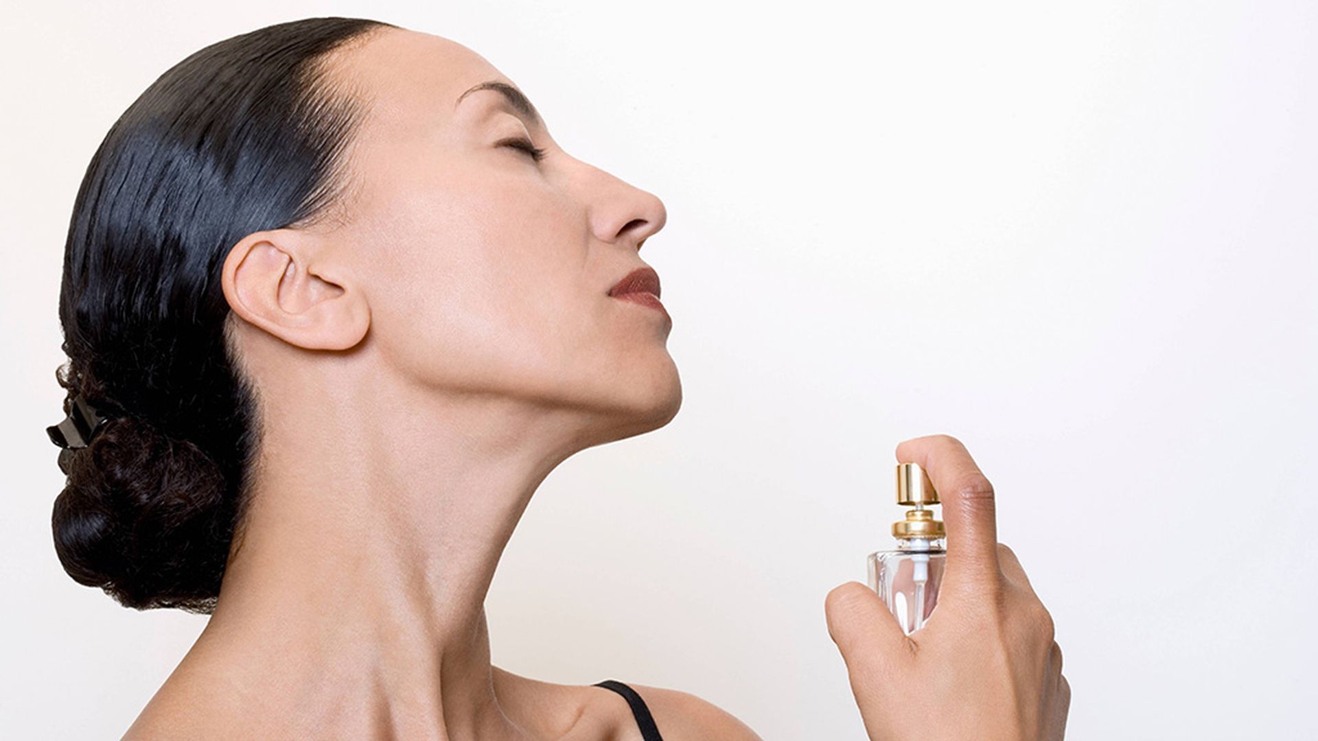 woman using perfume