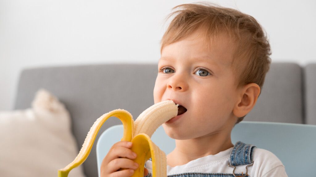  Niño comiendo un plátano