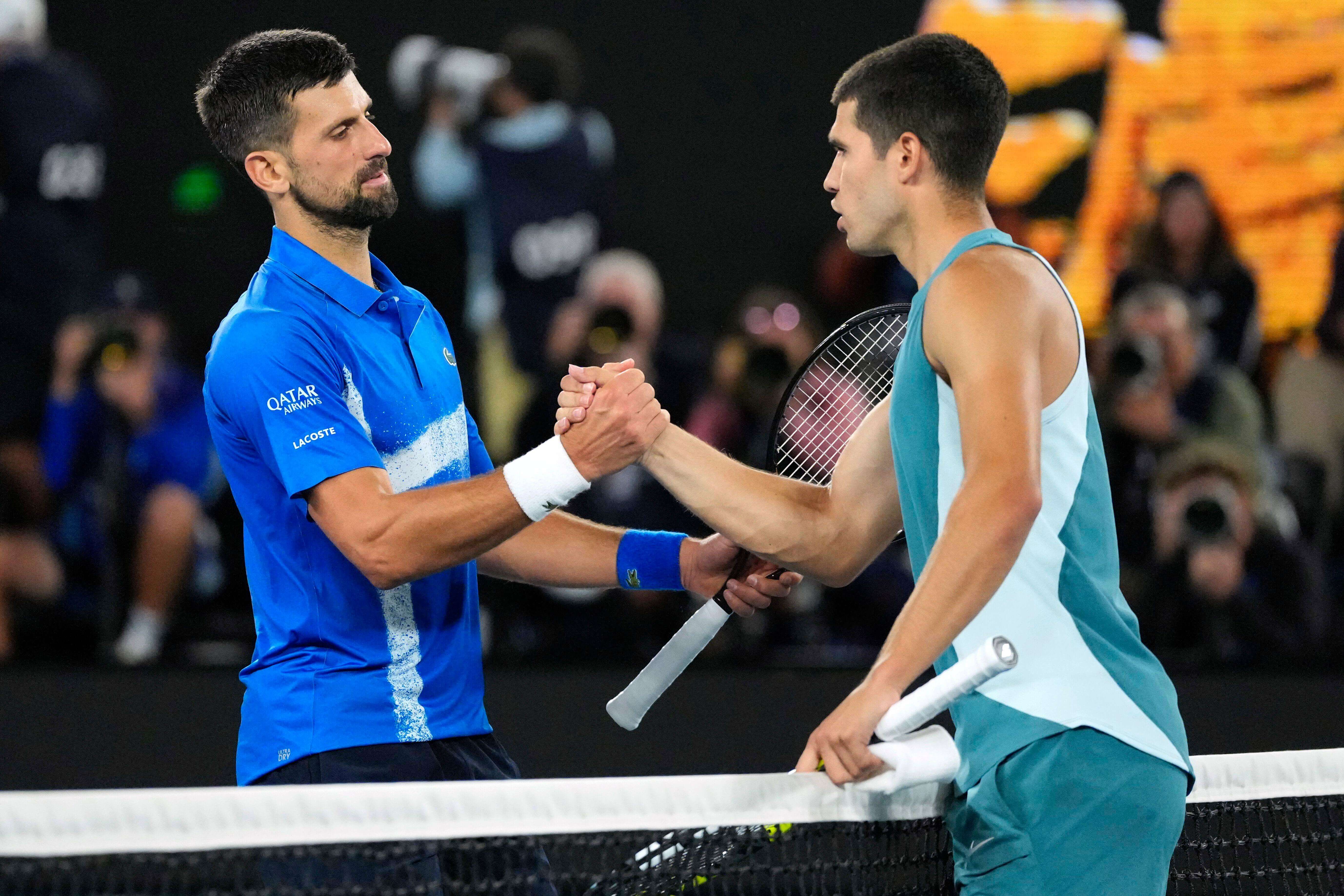 Novak Djokovic y Carlos Alcaraz se saludan en el Open de Australia.