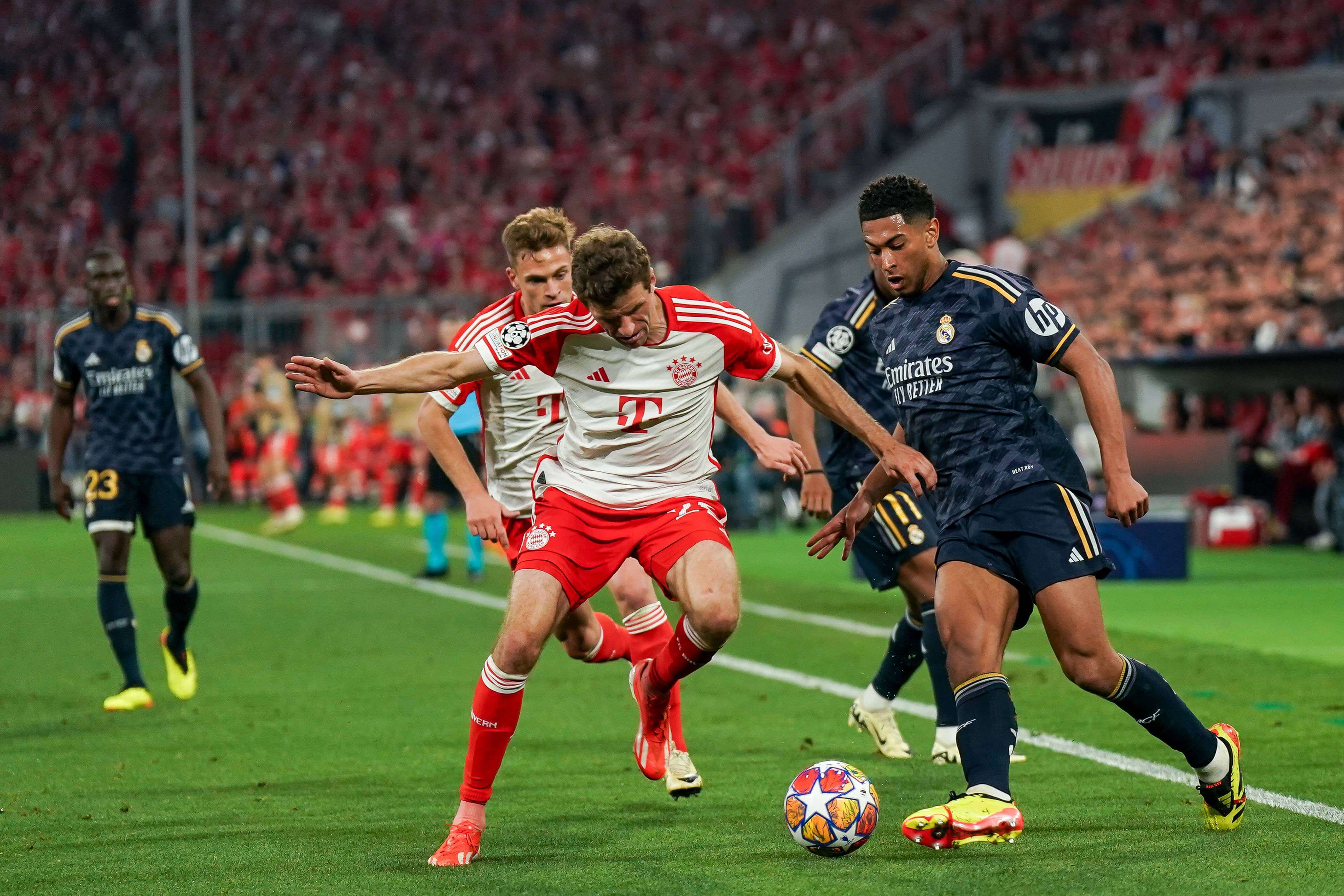  Jude Bellingham disputa un balón con Thomas Müller en el Bayern-Real Madrid.