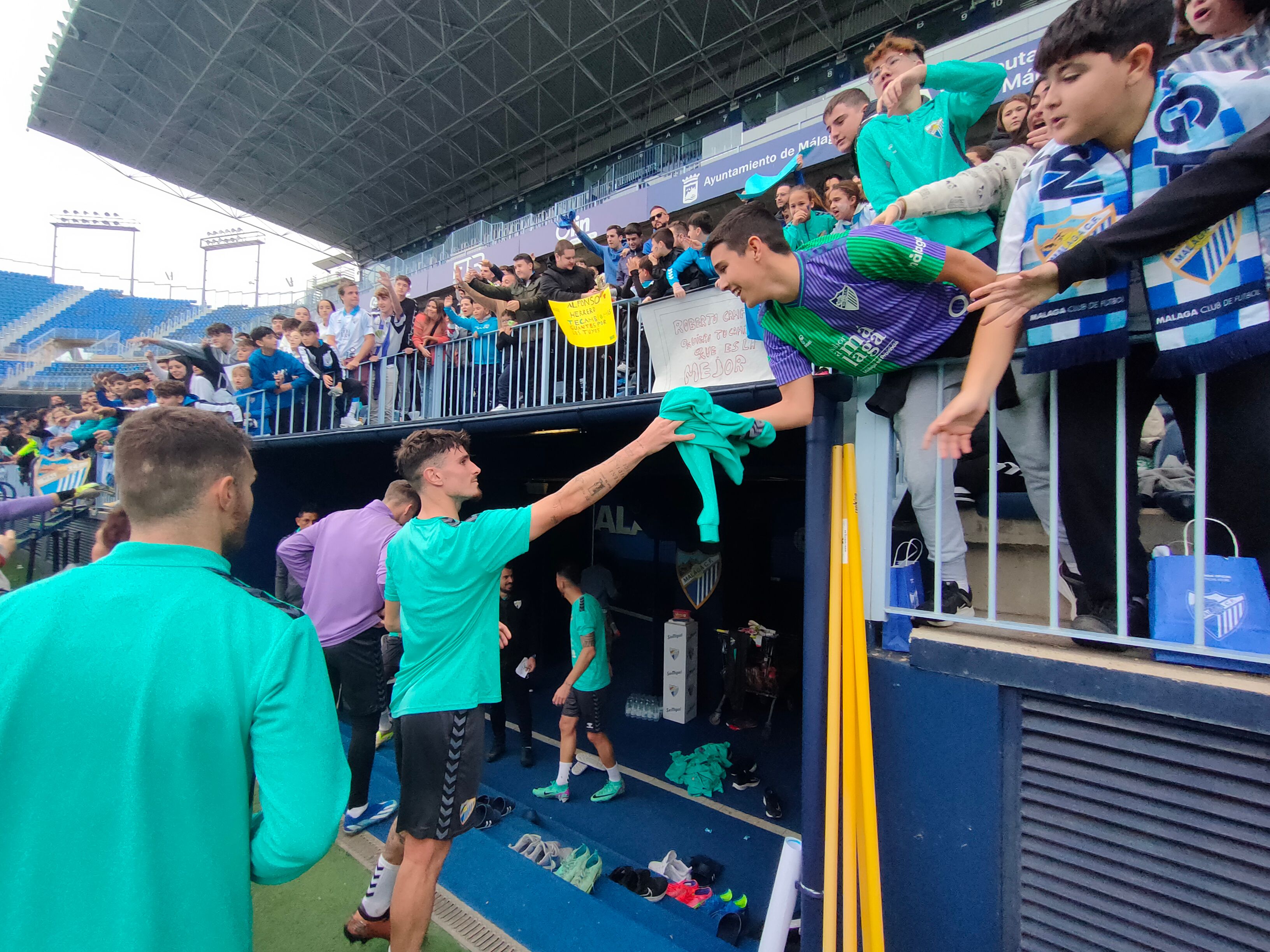 Murillo regala una sudadera a un aficionado malaguista.