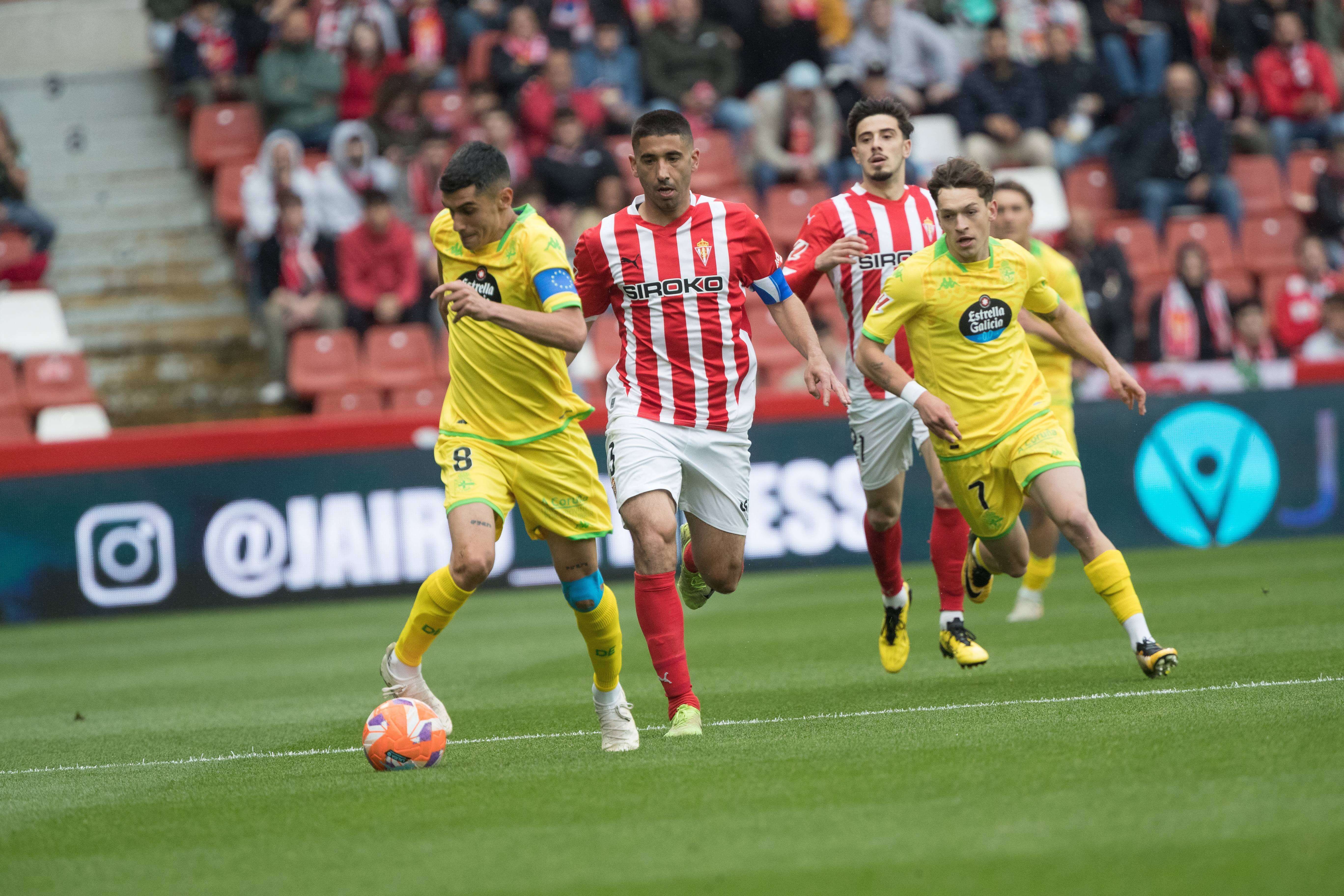  Diego Villares conduce delante de Cote en el Sporting-Deportivo.