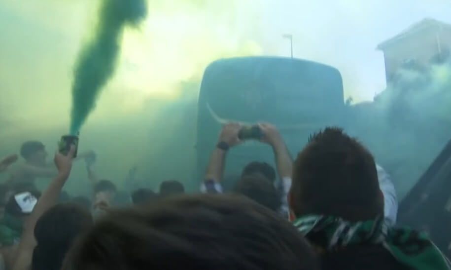 Fuegos artificiales y bengalas en el recibimiento al autobús del Betis