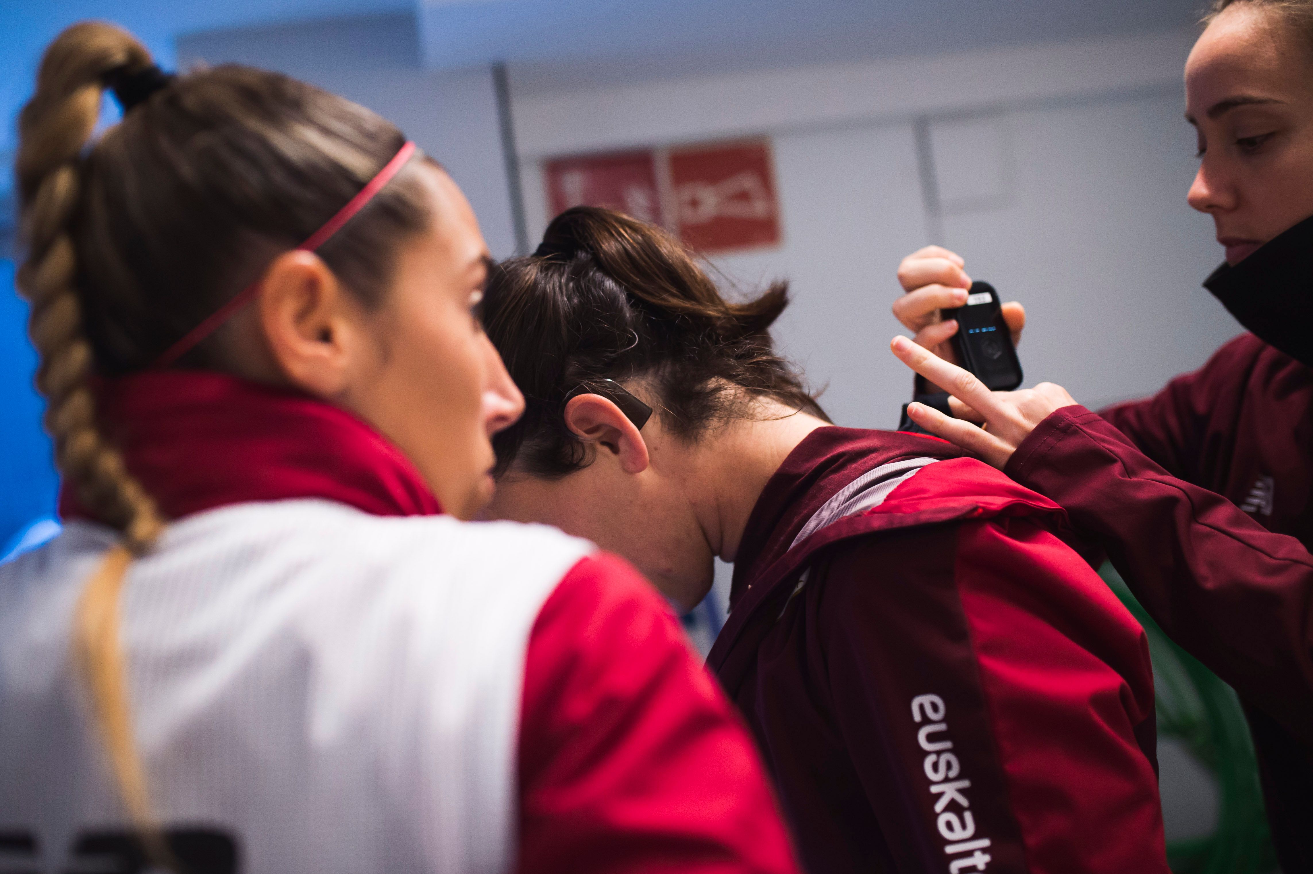 Una compañera ayuda a Eunate a colocarse su implante coclear.