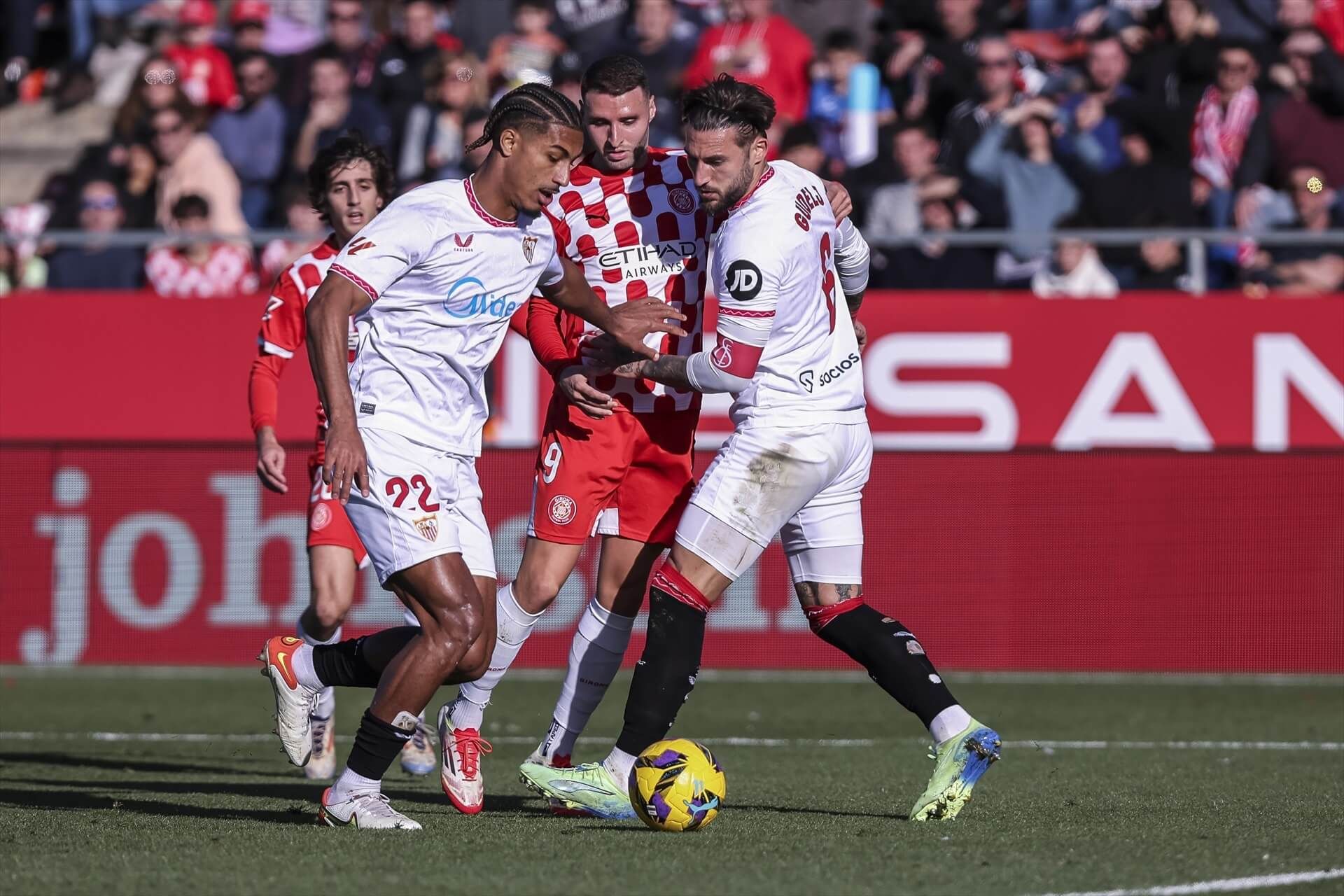 Abel Ruiz pelea un balón con Badé y Gudelj en el Girona-Sevilla.