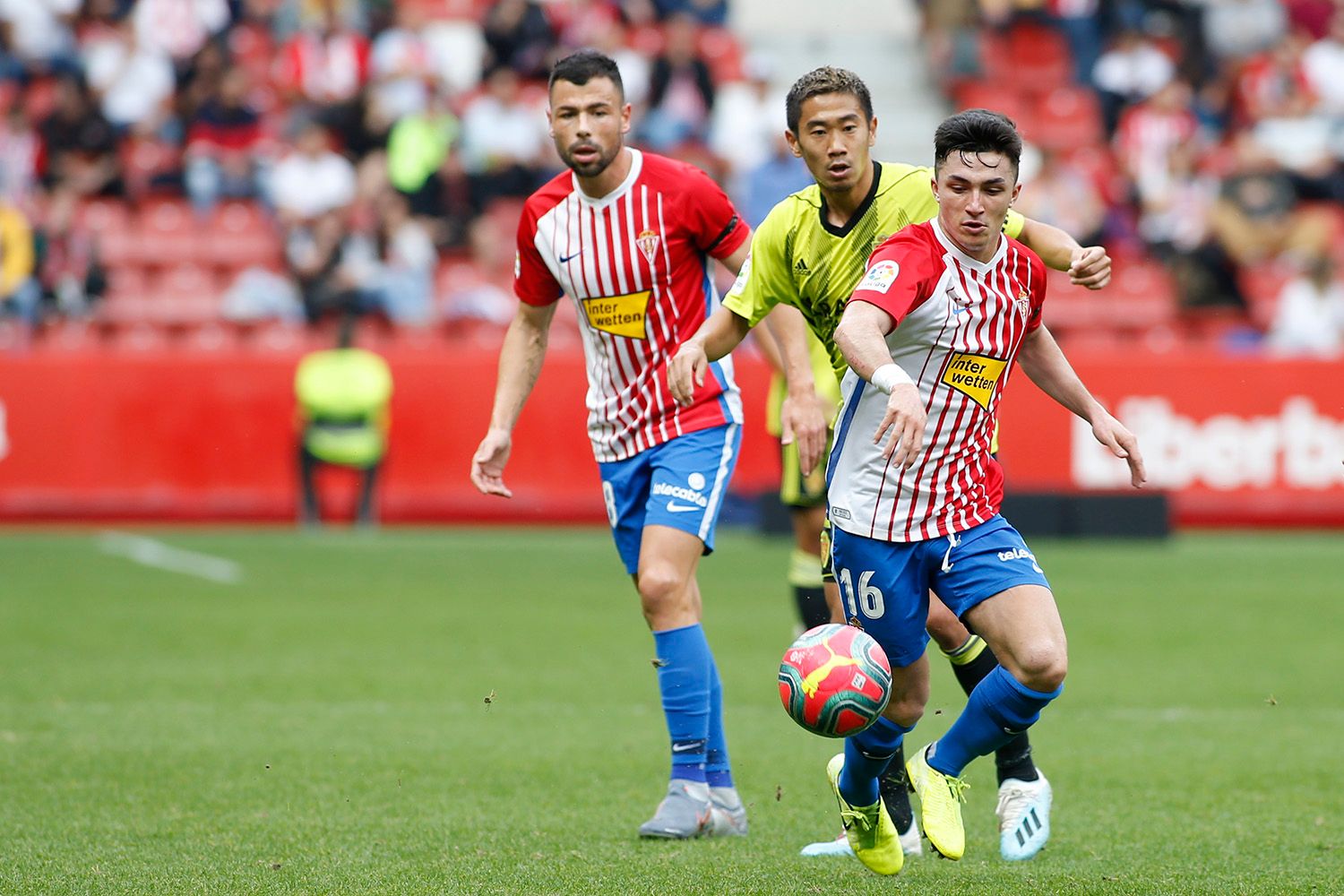  Kagawa trata de detener a Manu García en el Sporting-Real Zaragoza.