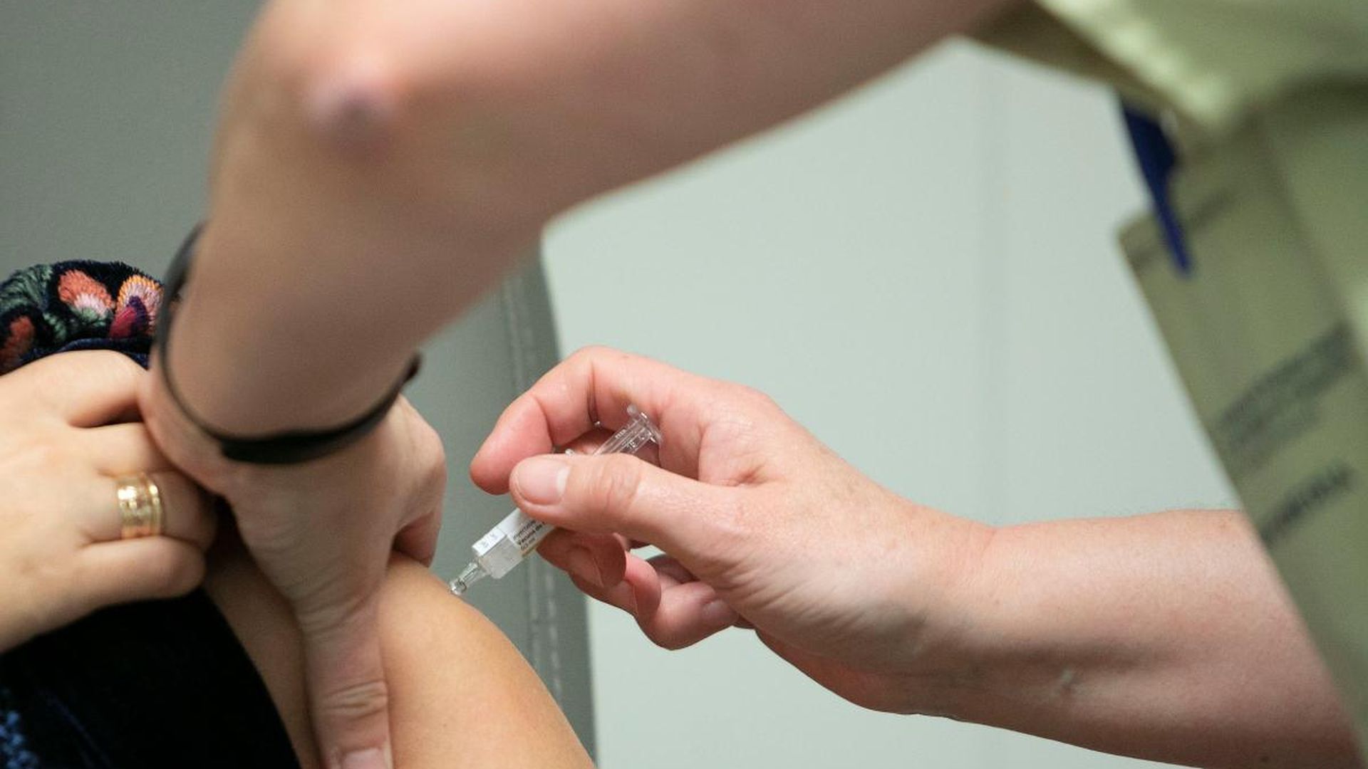 Una sanitario administrando una dosis de vacuna