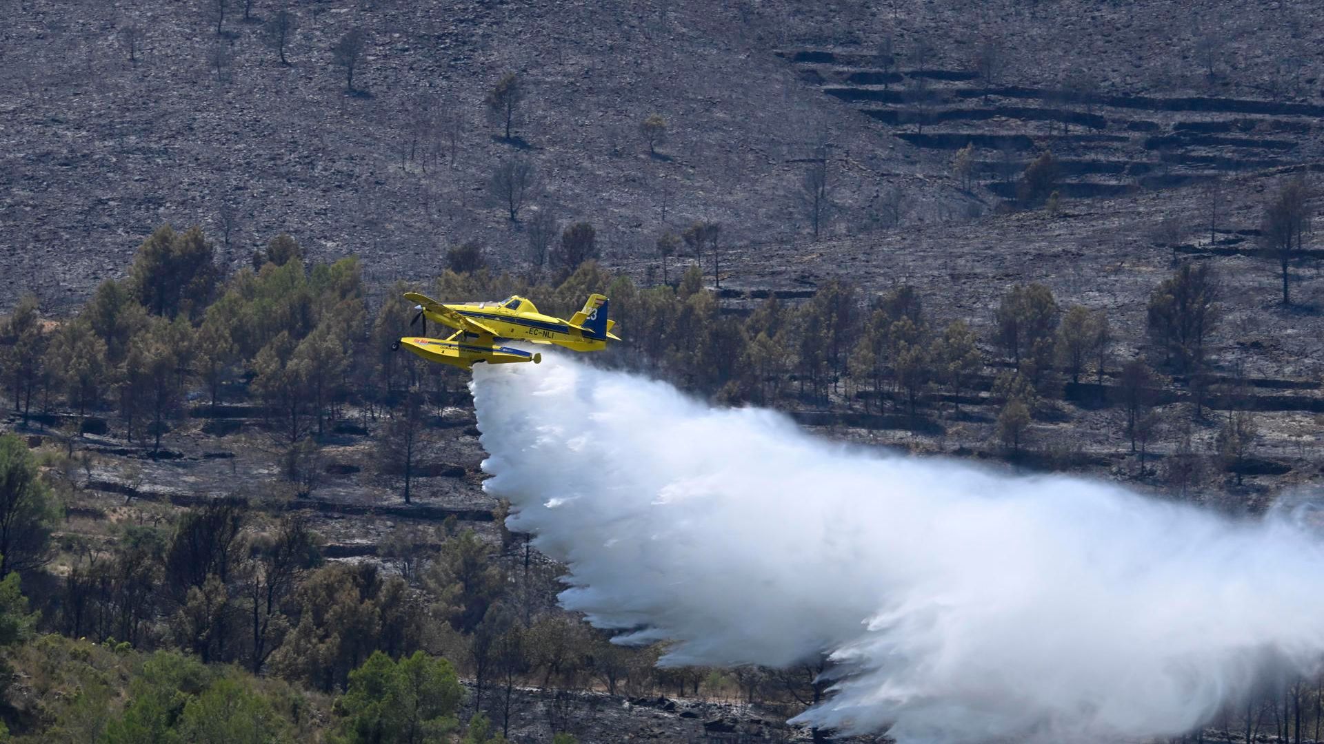 Un hidroavión de lucha contra el fuego descarga agua para la extinción del incendio forestal de Soneja, Castellón Un hidroavión de lucha contra el fuego descarga agua para la extinción del incendio forestal de Soneja, Castellón